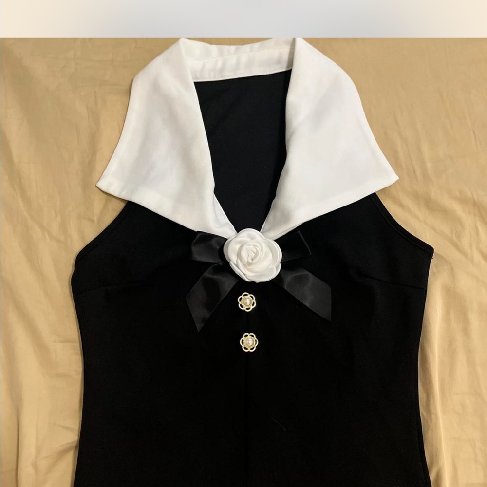 Black and White Sleeveless Top with Floral Accent